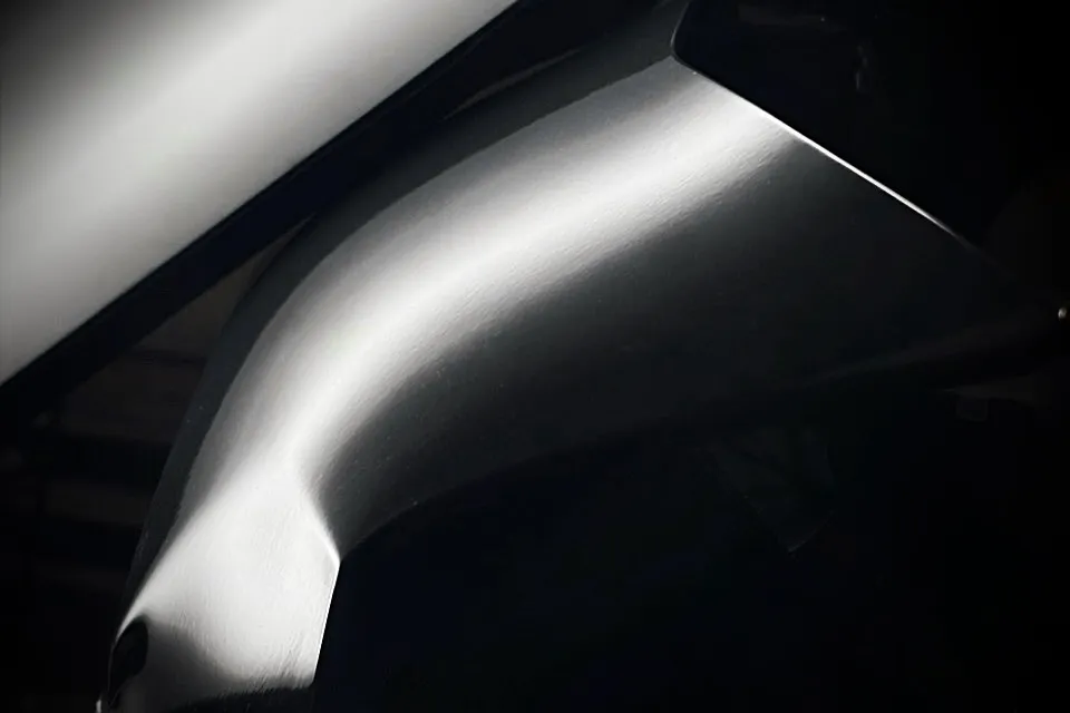 Paintless dent repair before and after on a black panel — Calgary — after